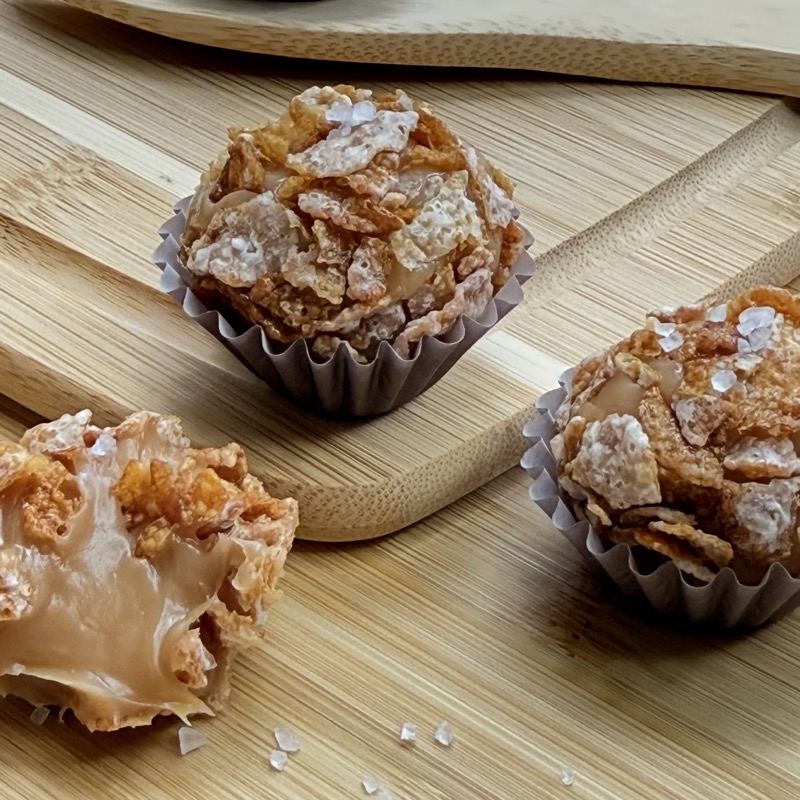 Salted caramel brigadeiros rolled in crunchy cereal flakes and topped with flaky sea salt