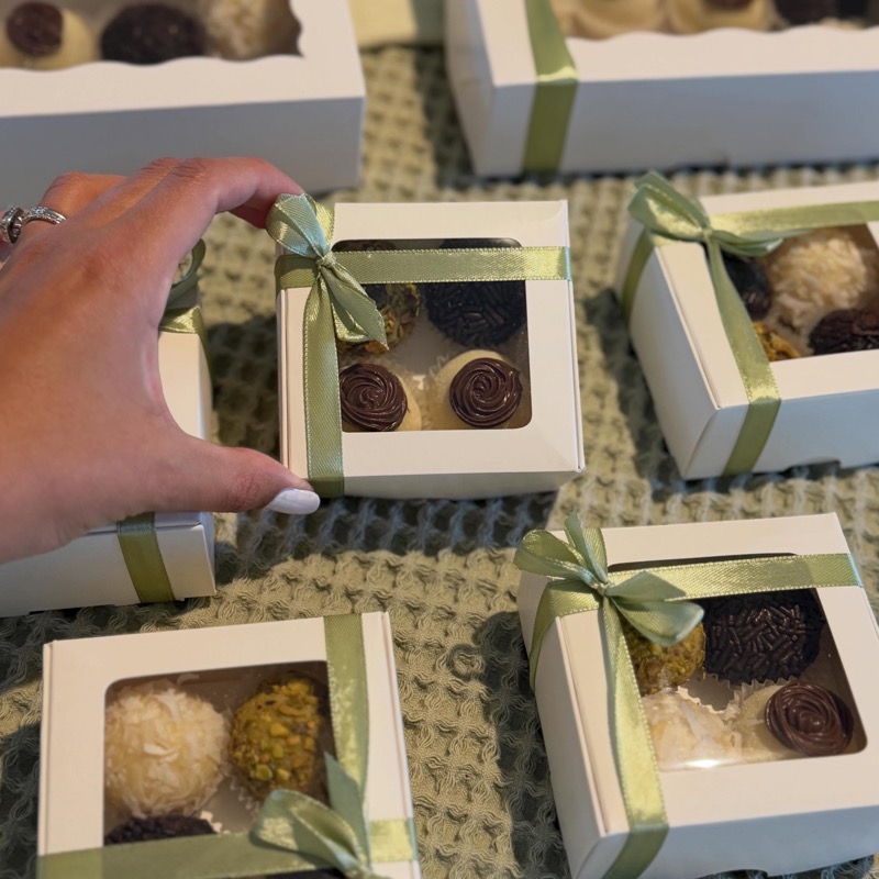Gift boxes of brigadeiros tied with sage ribbon
